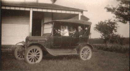 People in a vintage auto.