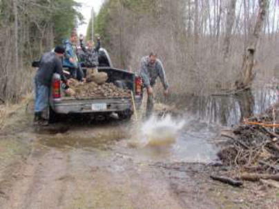 Flooded road repair with lots of rocks