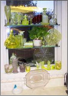 Kitchen window with glass shelving and figurines.