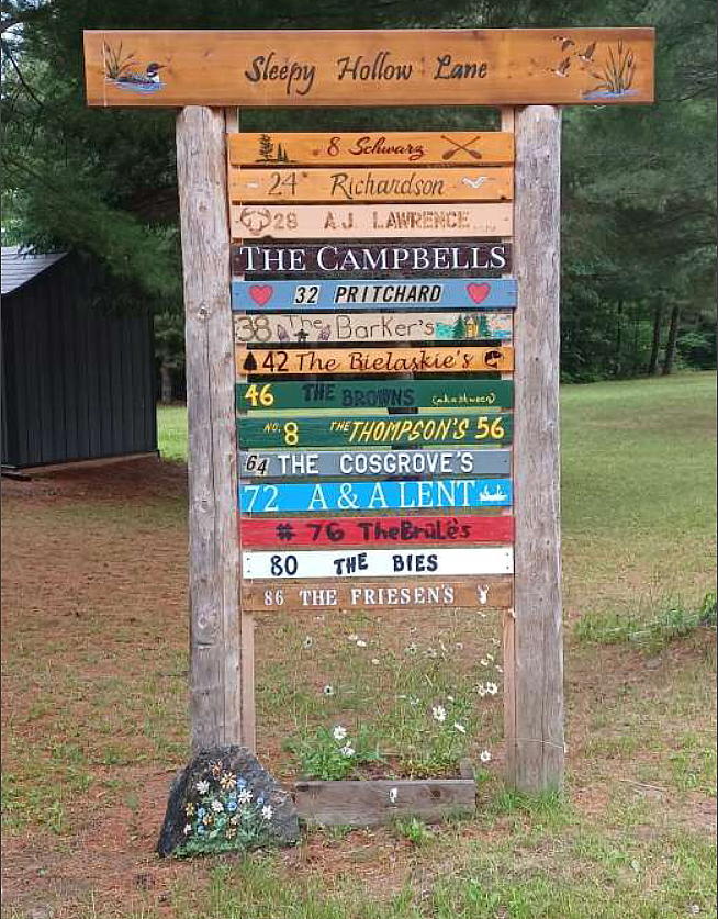 'New Sleepy Hollow cottages sign with owners' names