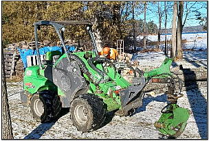 green farm tractor with bucket