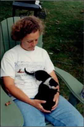 Sandy Bies with a lap-full of cats.