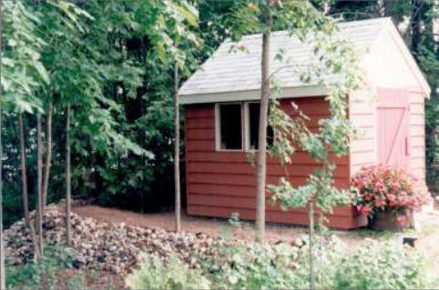 red shed sitting on a gravel pad