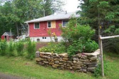 low stone wall at corner of cottage lot