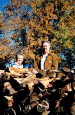 Ernie and Sandy Bies and a pile of firewood