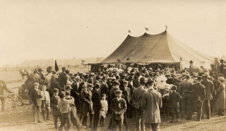 Photograph of fair or circus tents with crowd