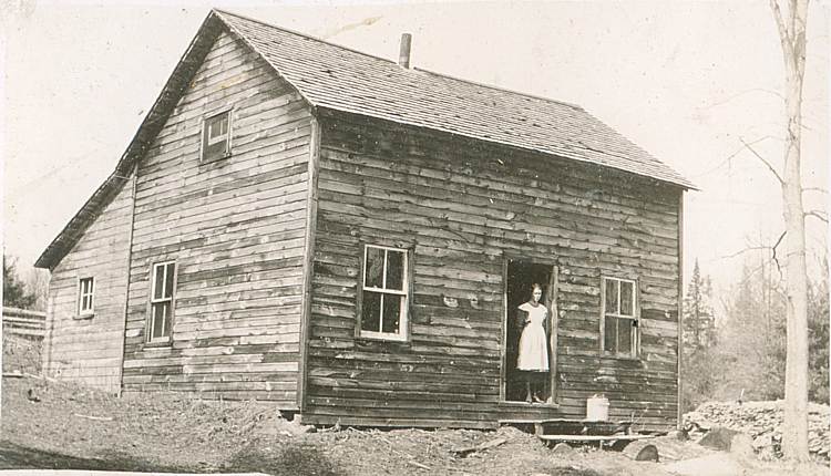 woman and log cabin