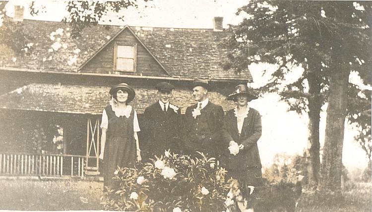 family in front of a house