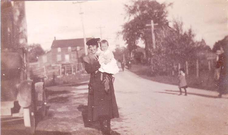 woman holding baby, probably in McDonalds Corners