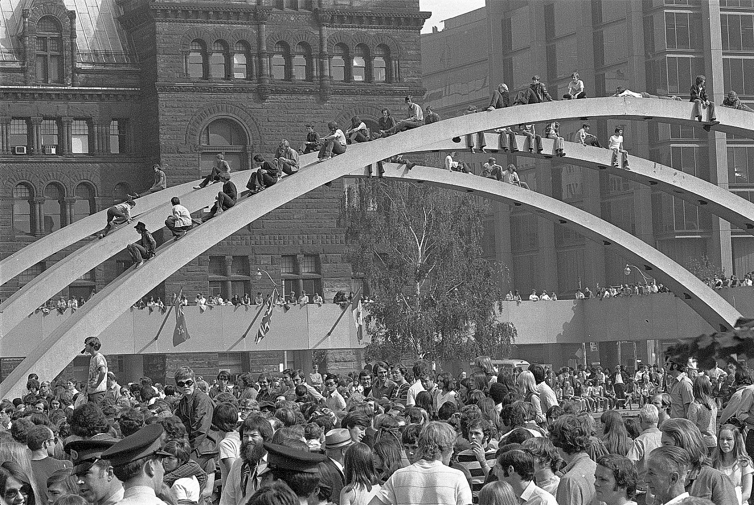 Crowd at Lighthouse Concert at City Hall, Toronto, 1970: crowd scene with people on top of City Hall arches